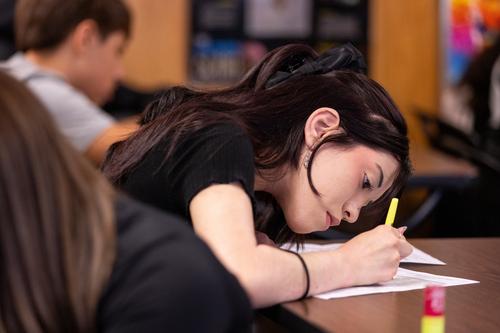 A student highlights their homework